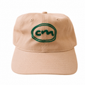 A white baseball cap with a green embroidered oval logo on the front, photographed against a plain white background.