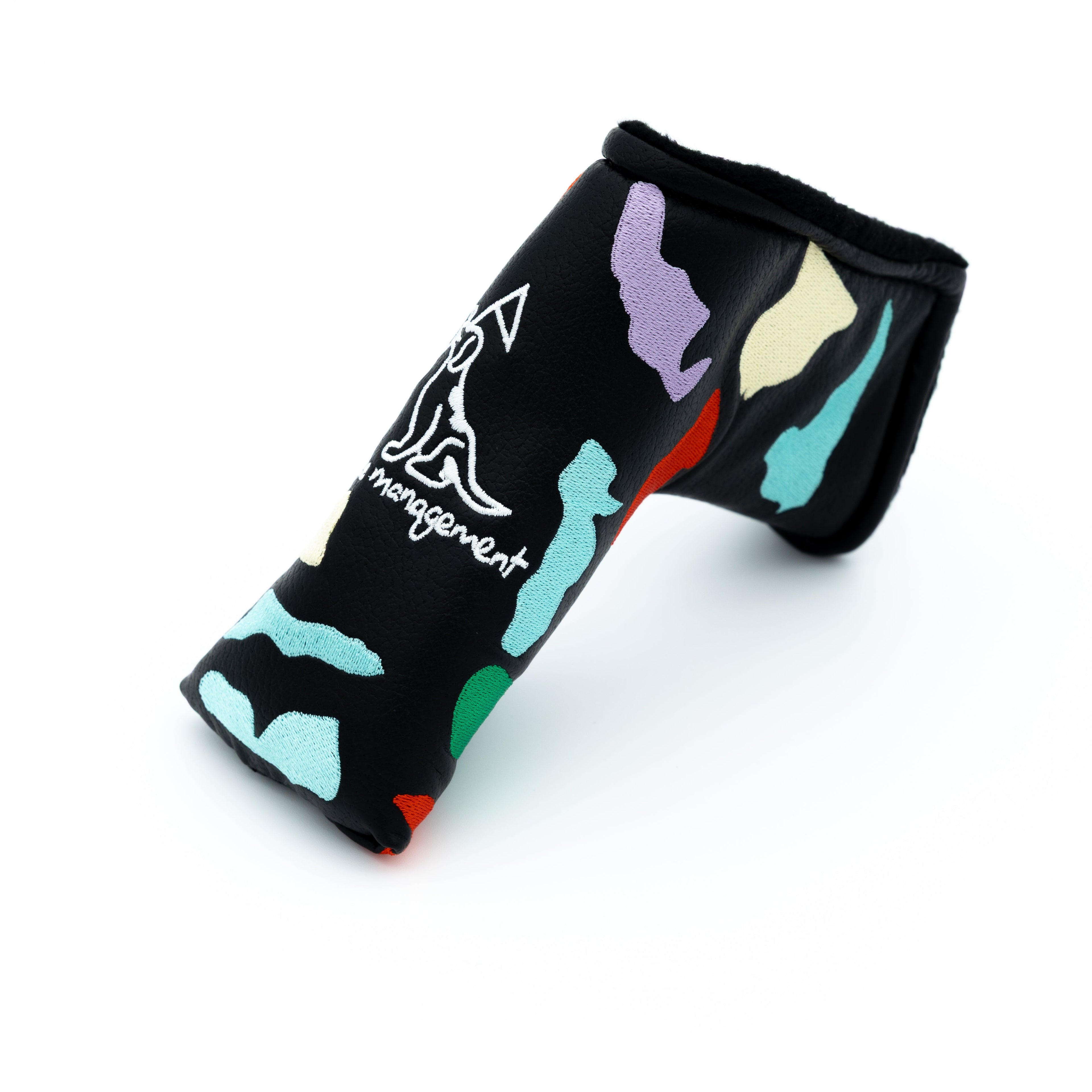 A black golf putter headcover featuring a colorful abstract pattern with a white stylized logo and the words 'course management' printed on the side.
