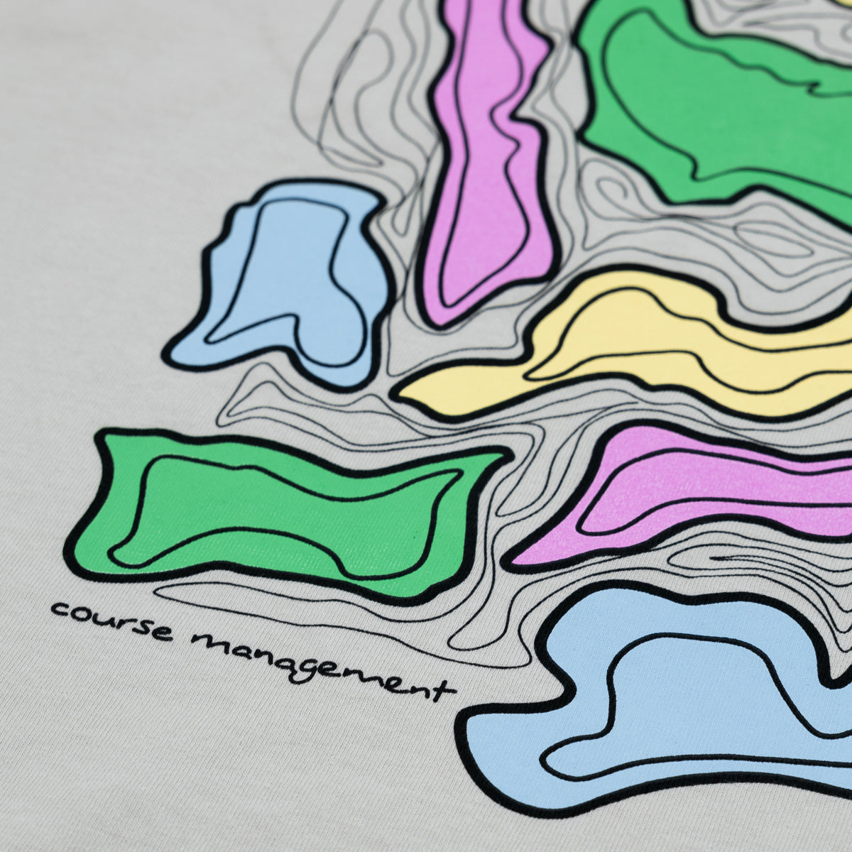 A close-up of an off-white fabric surface featuring a colorful topographical graphic with wavy outlined shapes in green, pink, yellow, blue, and orange, plus the handwritten text 'course management'.