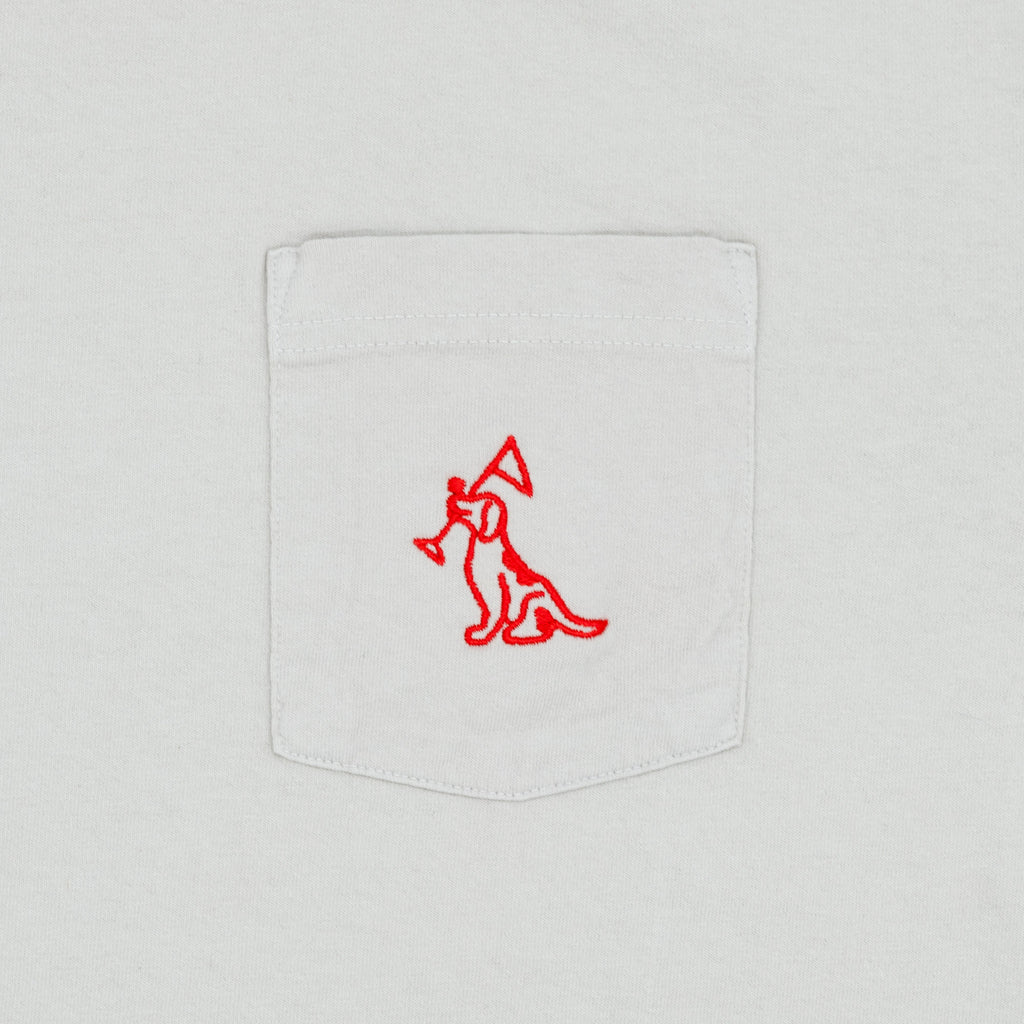 Close-up of a white pocket t-shirt featuring a red embroidered logo of a dog on the pocket.