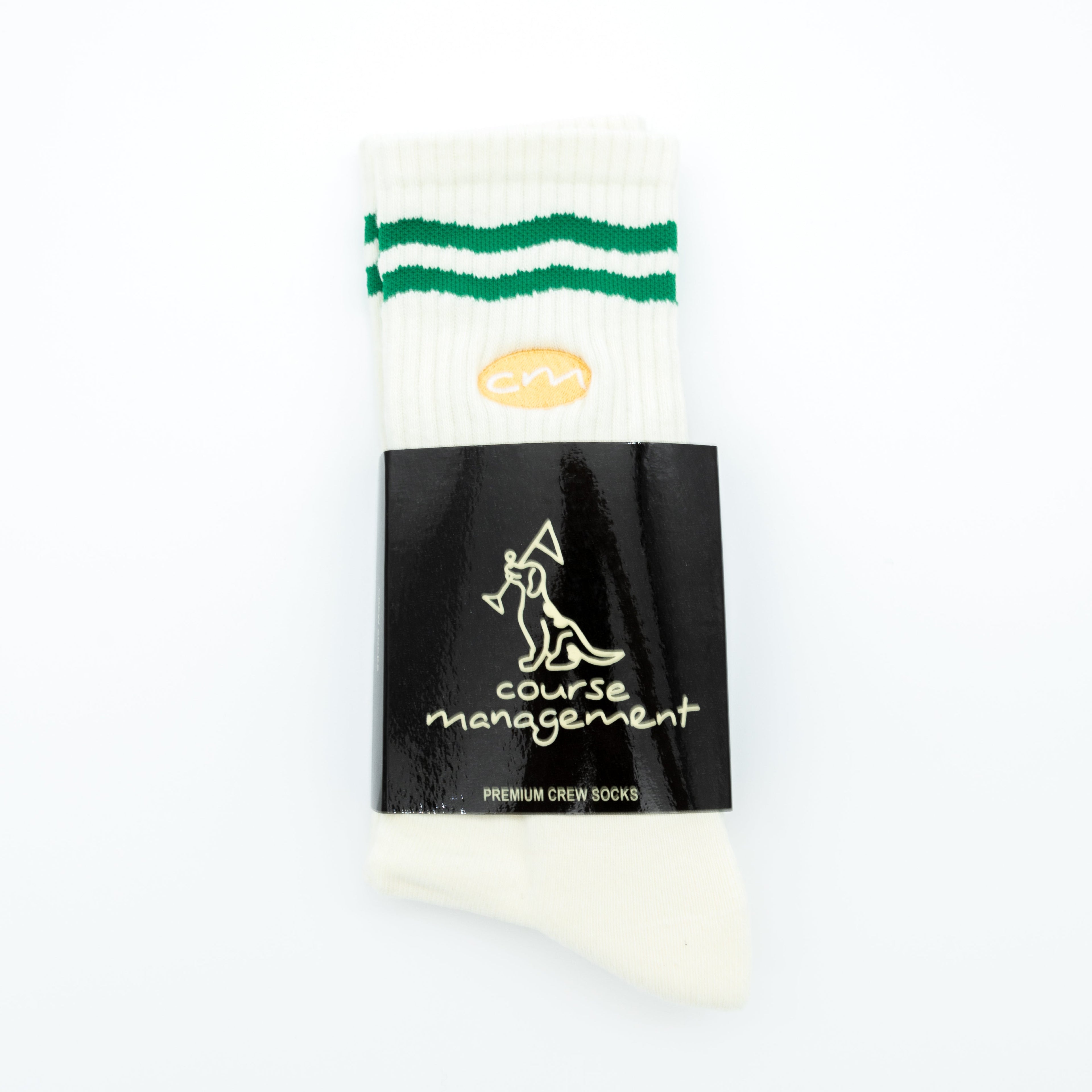 A single white crew sock with two green stripes near the cuff and a black paper band labeled 'course management' and 'PREMIUM CREW SOCKS', photographed on a plain white background.