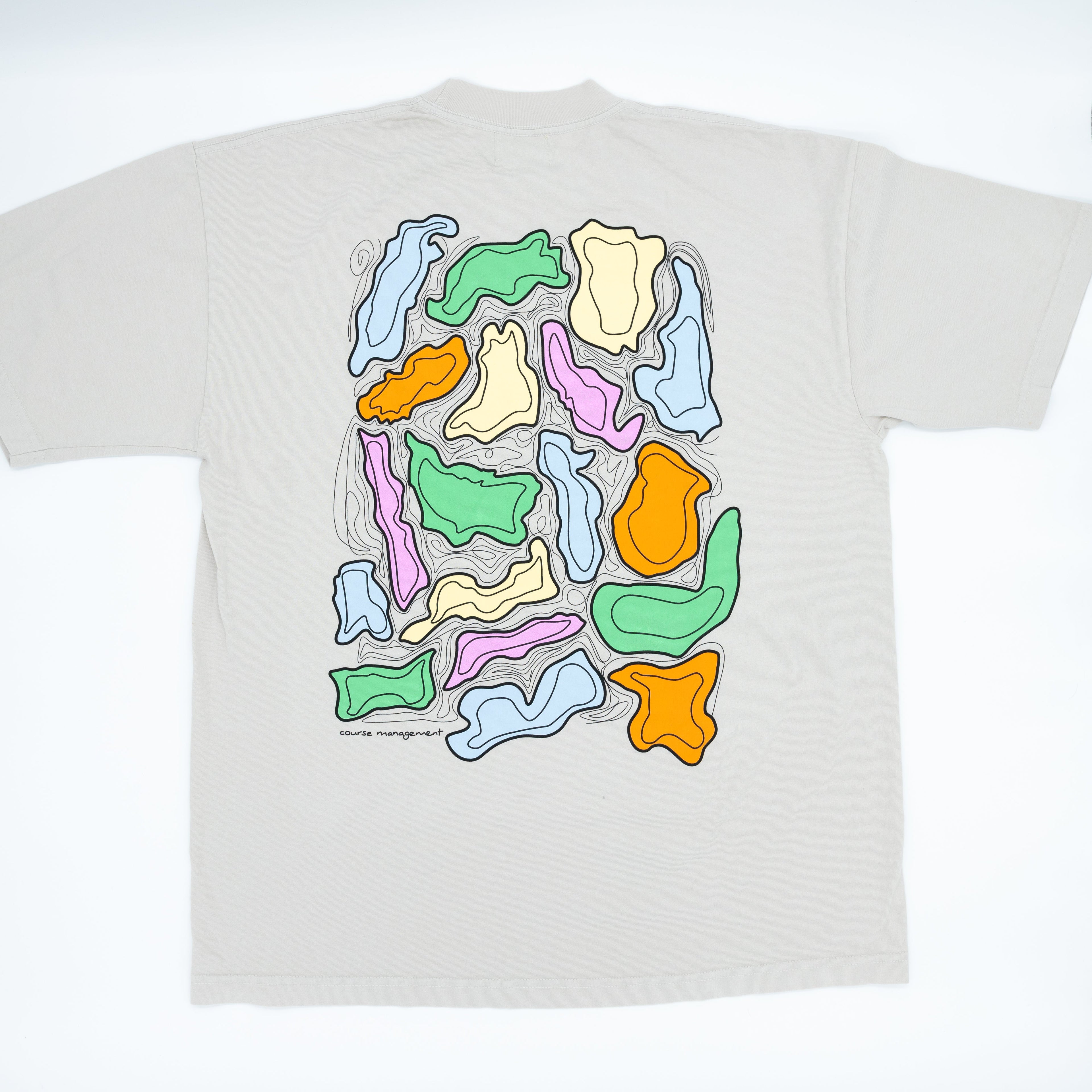 A light beige t-shirt shown flat against a white background, featuring a large graphic print on the back with abstract wavy shapes.