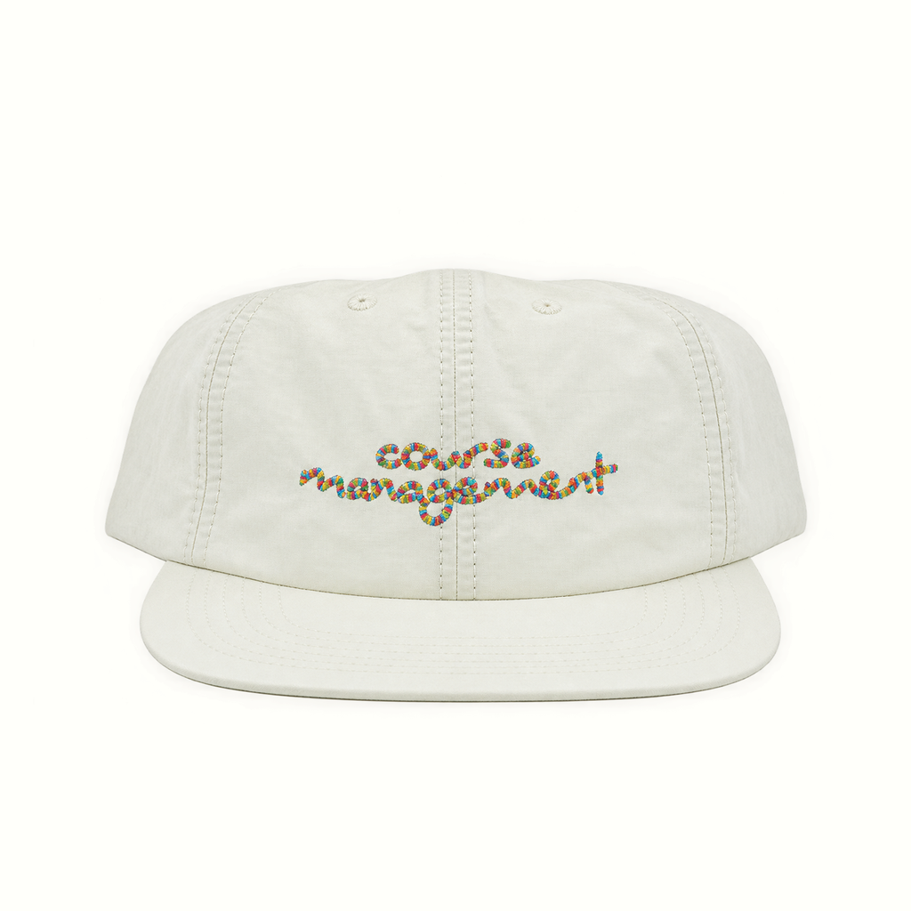 An off-white cotton flat-brim cap with 'course management' embroidered across the front in a multicolor wavy script, set against a plain white background.