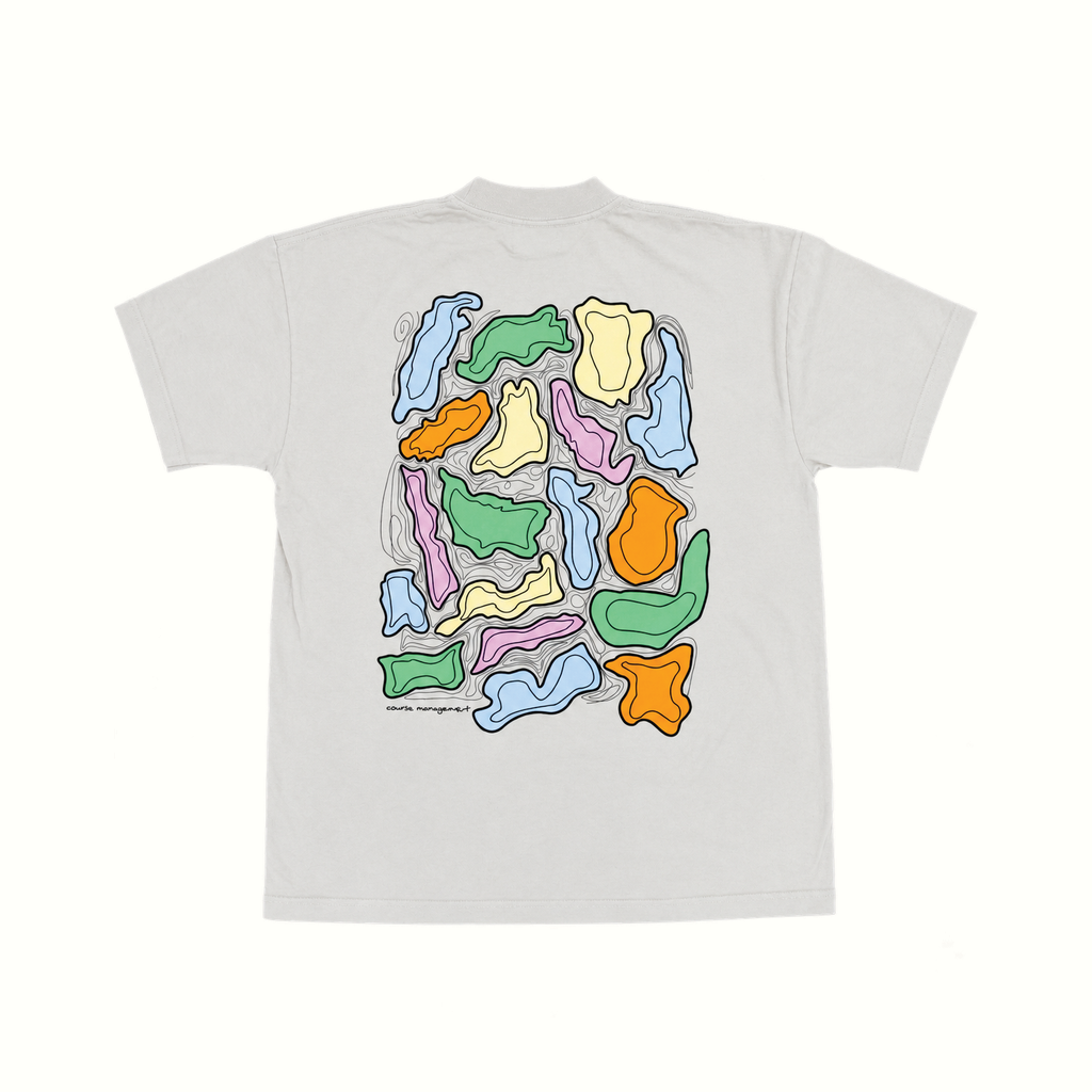 An off white short-sleeve t-shirt shown from the back, featuring a large graphic print of colorful abstract organic shapes in green, blue, orange, yellow, and pink.